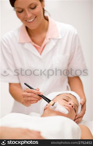 Facial mask - woman at beauty salon getting treatment
