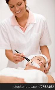 Facial mask - woman at beauty salon getting treatment