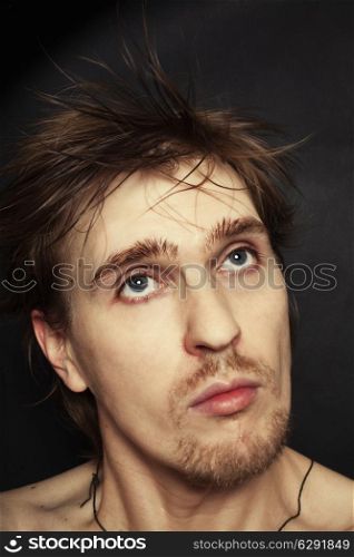 Facial portrait of a beautiful young blond blue-eyed man with a stylish hairstyle hairdo