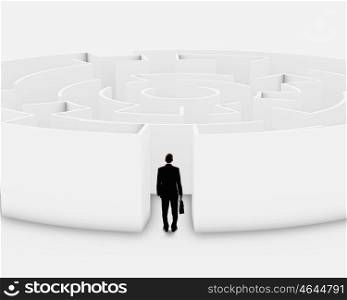 Facing challenge. Successful businessman standing near the entrance of labyrinth