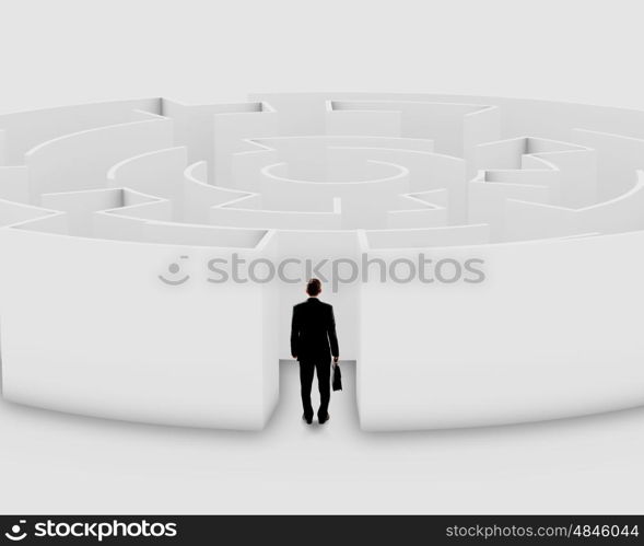 Facing challenge. Successful businessman standing near the entrance of labyrinth