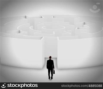 Facing challenge. Successful businessman standing near the entrance of labyrinth