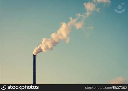 Factory chimney with white smoke