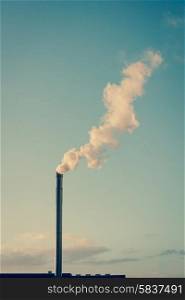 Factory chimney with white smoke