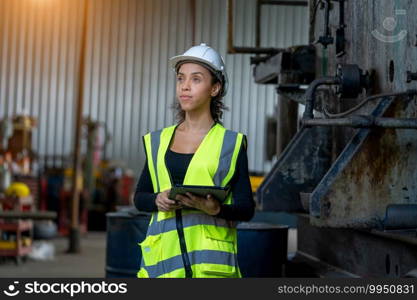 Factory female worker working and checking with clipboard in hands taking necessary notes at plant.