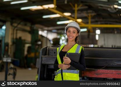 Factory female worker working and checking with clipboard in hands taking necessary notes at plant.