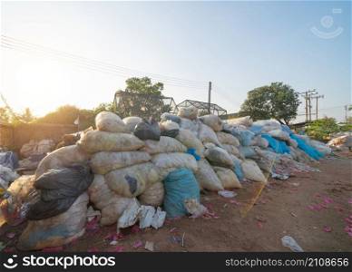 Factory industry with stack of different types of large garbage dump, plastic bags, bottles and trash bins in urban area in Environmental pollution concept.