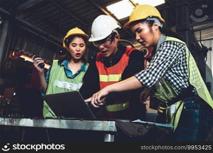 Factory job workers working and discussing manufacturing plan in the factory . Industry and engineering concept .