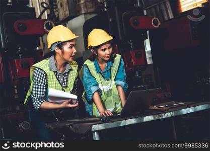 Factory job workers working and discussing manufacturing plan in the factory . Industry and engineering concept .. Factory job workers working and discussing manufacturing plan in the factory
