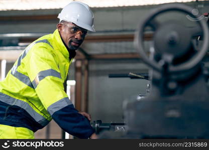 Factory worker or engineer do machine job in adept manufacturing workshop . Industrial people and manufacturing labor concept .. Factory worker or engineer do machine job in adept manufacturing workshop