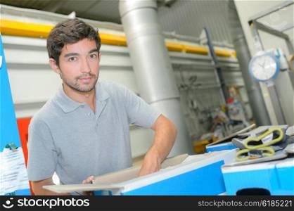 Factory worker packing carton