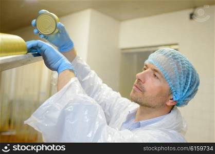 factory worker stocking cans