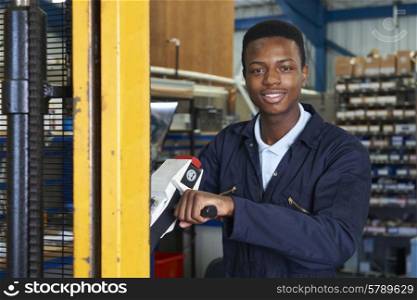 Factory Worker Using Powered Fork Lift To Load Goods