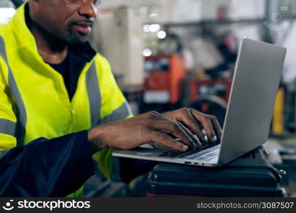 Factory worker working with laptop computer to do adept procedure checklist . Factory production line operator occupation quality control concept .. Factory worker working with laptop computer to do adept procedure checklist