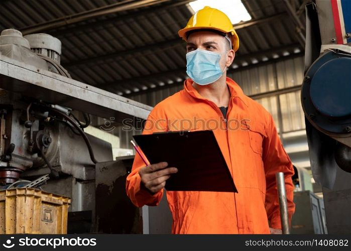 Factory workers with face mask protect from outbreak of Coronavirus Disease 2019 or COVID-19. Concept of protective action and quarantine to stop spreading of Coronavirus Disease 2019 or COVID-19.