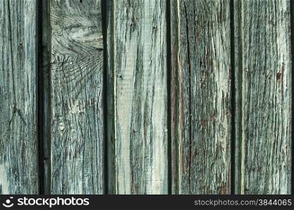 Fade blue old painted wooden board fence wall surface closeup as background