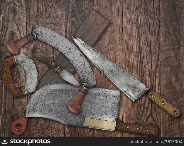 faded colors if a vintage kitchen knives and sharpening tools collage over old wooden table, space for your text