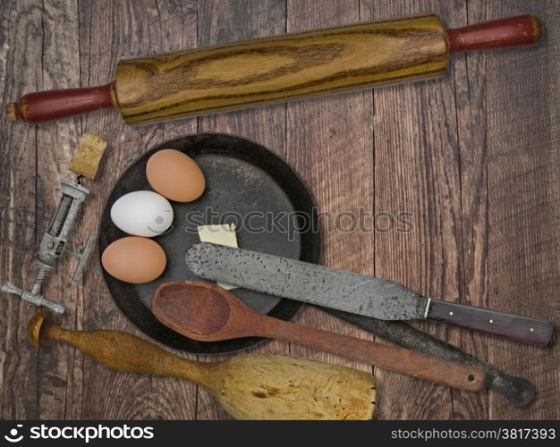 faded colors of a vintage utensils set, skillet, eggs,butter, space for your text