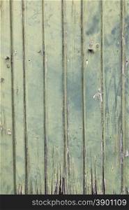faded green vertcal planks of old wooden door
