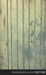 faded green vertcal planks of old wooden door