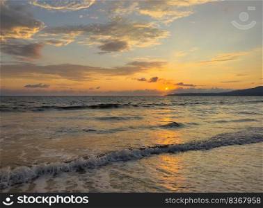 Fading golden sunset over the Pacific Ocean in Mexico for a tropical background of nature 