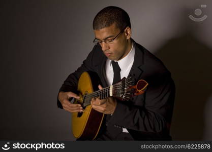 fado musician with a portuguese guitar, studio