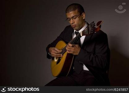 fado musician with a portuguese guitar, studio