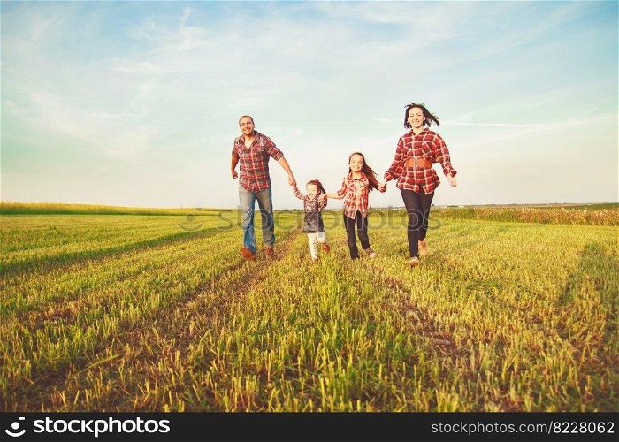 fafamily running together in the field. family running together in the field
