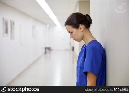 fail, people, health care and medicine concept - sad female nurse at hospital corridor