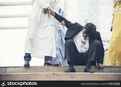 Failure businessman going bankrupt try to stand up when a friend are helping.