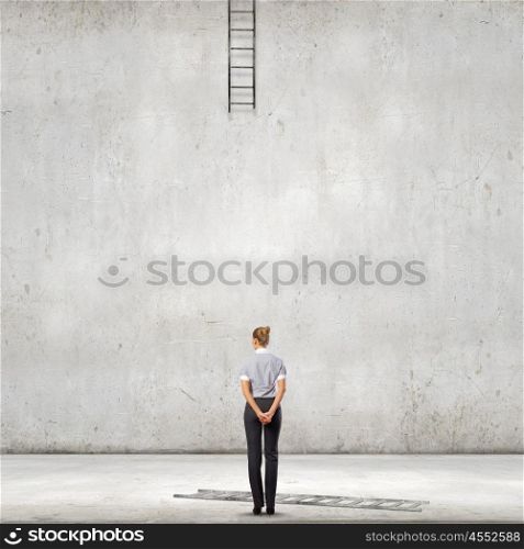 Failure in business. Back view of businesswoman and broken ladder going up