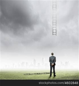 Failure in business. Rear view of businessman and broken ladder to sky