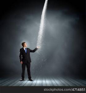 Failure in business. Young businessman under raining sky. Failure concept