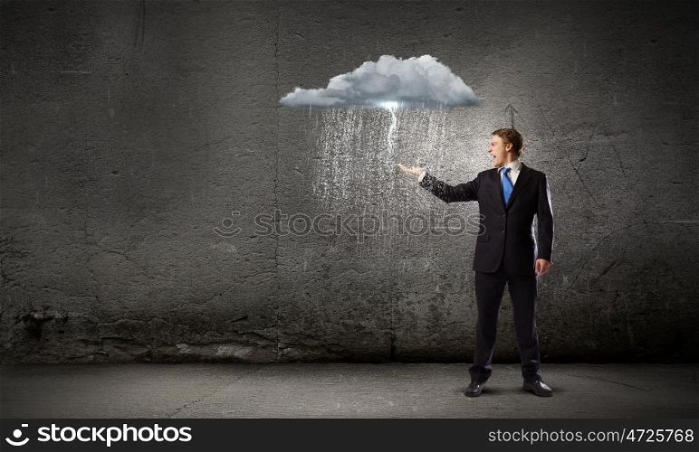 Failure in business. Young businessman under raining sky. Failure concept