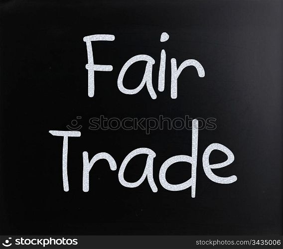 ""Fair trade" handwritten with white chalk on a blackboard."