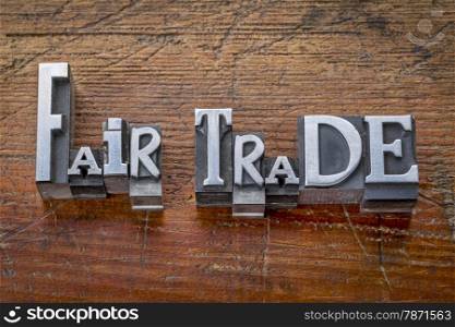 fair trade words in vintage metal type printing blocks over grunge wood - ethical business concept