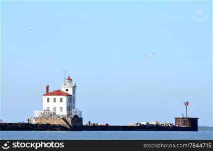 "Fairport Harbor Lighthouse on Lake Erie. Fairport Harbor Lighthouse Is "Green" Using Solar Energy. This is a large harbour and this lighthouse has been guiding and keeping freighters safe for many years."