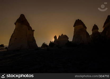 Fairy tale chimneys in Cappadocia, tourist attraction places to fly with hot air balloons. Goreme, Cappadocia, Turkey. Fairy tale chimneys in Cappadocia on the background of blue sky in Turkey.The great tourist attraction of Cappadocia one of the best places to fly with hot air balloons. Goreme, Cappadocia, Turkey