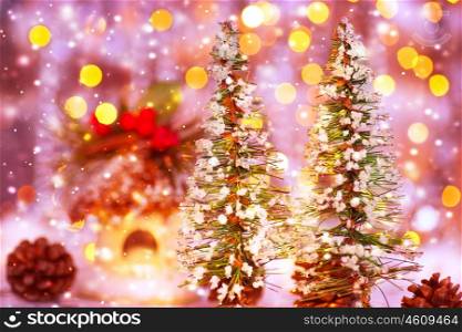 Fairytale Christmas, two little decorated Christmas trees on festive lights background, beautiful still life, cute home decoration