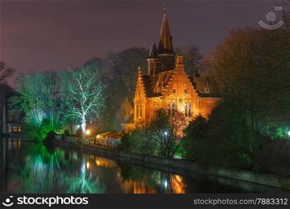 Fairytale night landscape with a medieval house on Lake Minnewater in Bruges, Belgium
