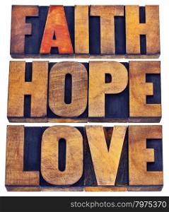 faith, hope and love - a collage of isolated words in vintage letterpress wood type stained by color inks