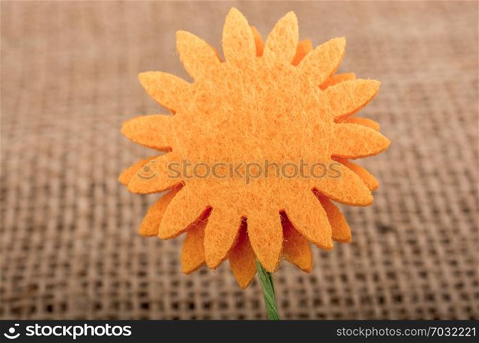 Fake flower placed on brown background