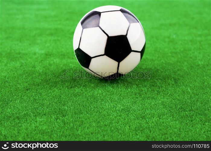 Fake soccer ball on a fake green grass field