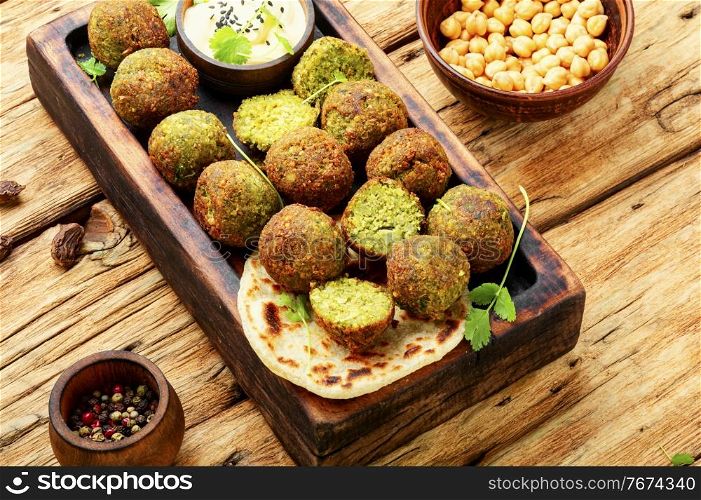 Falafel balls on a wooden cutting board.Arabic snack falafel. Delicious falafel balls