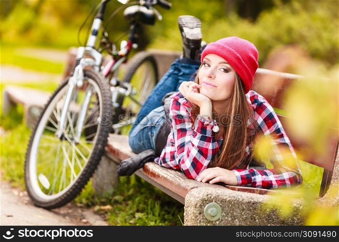 Fall active lifestyle concept,. Beauty young woman sporty casual girl relaxing in autumnal park with bicycle, outdoor