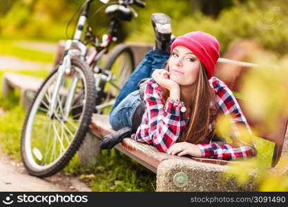 Fall active lifestyle concept,. Beauty young woman sporty casual girl relaxing in autumnal park with bicycle, outdoor