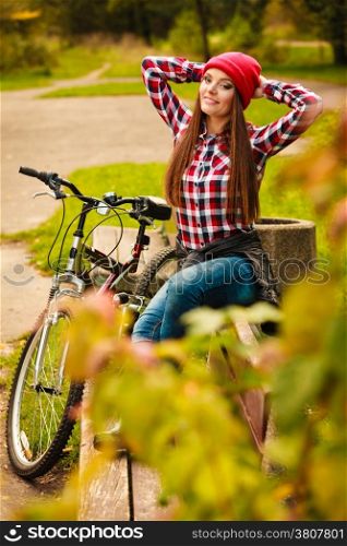Fall active lifestyle concept,. Beauty young woman sporty casual girl relaxing in autumnal park with bicycle, outdoor