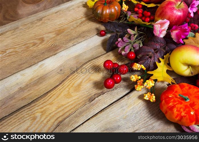 Fall arrangement with pumpkins and pink flowers, copy space. Fall arrangement with pumpkins, apples, red berries, pink flowers, copy space