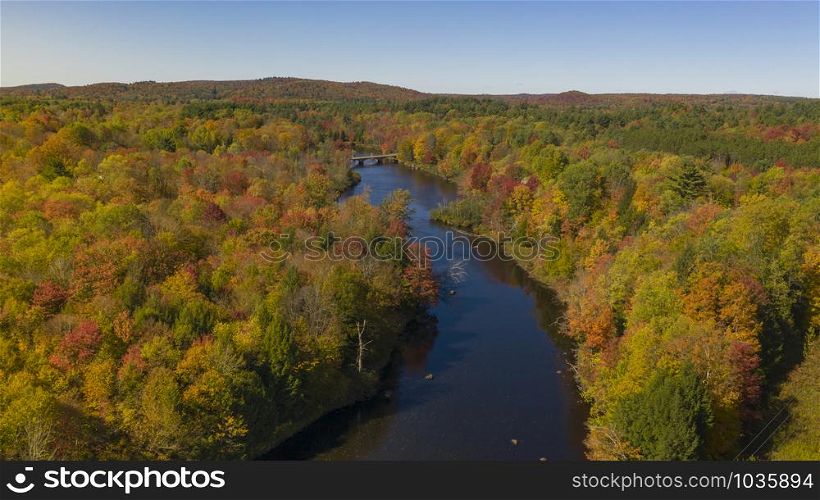 Fall color is more saturated at sunset over the Oswegatche River Adirondack Park Mountains New York