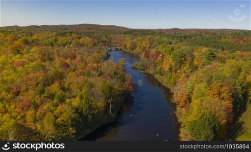 Fall color is more saturated at sunset over the Oswegatche River Adirondack Park Mountains New York